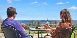 2 People Overlooking Buttonwood Grove View Vineyards Drinking Rose Wine